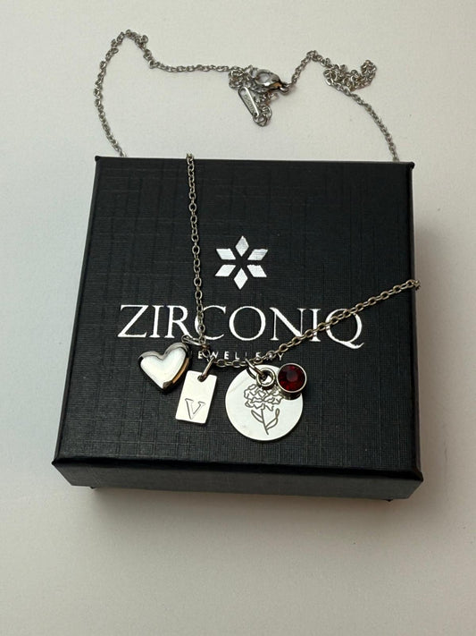 Necklace with charms on a Zirconiq branded box