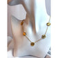 Gold necklace with floral designs on a mannequin bust.