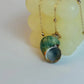 Necklace with a green shell pendant on a light background