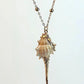 Shell pendant necklace on a light gray background